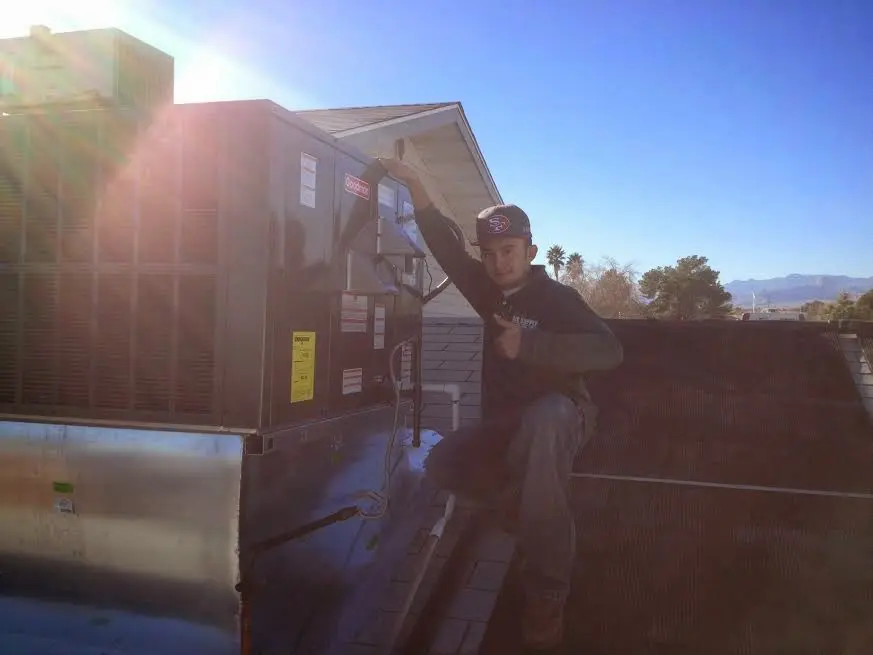 HVAC technician performing HVAC Inspection on a rooftop unit in Palmer Town